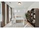 Comfortable home office with a sleek white desk, stylish shelving, and natural light from multiple windows at 766 Maynard Ln, Summerville, SC 29486