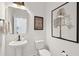 Stylish powder room with pedestal sink, elegant mirror, and decorative wall art at 766 Maynard Ln, Summerville, SC 29486
