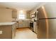 Kitchen with stainless steel appliances, granite countertops, and ample natural light at 8285 Little Sydneys Way, North Charleston, SC 29406
