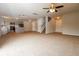 Open-concept living space with neutral walls, ceiling fan and kitchen area at 8285 Little Sydneys Way, North Charleston, SC 29406
