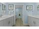 Bright and airy bathroom with dual vanity sinks and view to a toilet room at 8400 Camp Gregg Ln, North Charleston, SC 29418