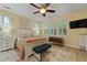 Bright bedroom features neutral walls, a ceiling fan, natural light, and a decorative rug at 8400 Camp Gregg Ln, North Charleston, SC 29418