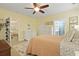 Bedroom with ceiling fan has a view of a seating area and ensuite bathroom at 8400 Camp Gregg Ln, North Charleston, SC 29418