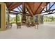 Covered patio featuring a fireplace, ample seating, and natural wood accents, creating a cozy community gathering space at 8400 Camp Gregg Ln, North Charleston, SC 29418