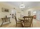 Bright dining room with wood floors, a modern chandelier, and views into the kitchen at 8400 Camp Gregg Ln, North Charleston, SC 29418