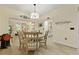 Bright dining room with wood floors, a modern chandelier, and views into the living room at 8400 Camp Gregg Ln, North Charleston, SC 29418