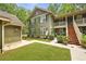 Charming two-story home with lush lawn, beautiful landscaping, and covered stairwell to upper floors at 8400 Camp Gregg Ln, North Charleston, SC 29418