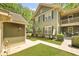 Charming two-story home with lush lawn, beautiful landscaping, and covered stairwell to upper floors at 8400 Camp Gregg Ln, North Charleston, SC 29418