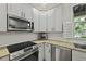Updated kitchen with white cabinets, stainless steel appliances and granite countertops at 8400 Camp Gregg Ln, North Charleston, SC 29418