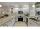 Modern kitchen featuring granite countertops, white cabinets, stainless appliances, and wood flooring at 8400 Camp Gregg Ln, North Charleston, SC 29418