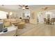 Spacious living room with view to kitchen, modern furnishings, and hardwood floors at 8400 Camp Gregg Ln, North Charleston, SC 29418