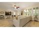 Open-concept living room with modern decor, ceiling fan and lots of windows at 8400 Camp Gregg Ln, North Charleston, SC 29418