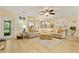 Bright living room featuring a large sectional sofa, ceiling fan, and lots of windows at 8400 Camp Gregg Ln, North Charleston, SC 29418
