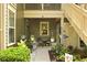 Cozy outdoor patio with table, chairs, and hanging plants for relaxing and entertaining guests at 8400 Camp Gregg Ln, North Charleston, SC 29418