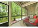 Screened porch with ceiling fan, seating and wooded view at 8400 Camp Gregg Ln, North Charleston, SC 29418