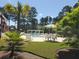 Community pool and deck area with seating and manicured lawn at 9430 Sweep Dr, Summerville, SC 29485