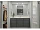Modern bathroom featuring a gray vanity, ample lighting, and a large mirror at 96 King Charles Cir, Summerville, SC 29485