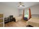 Charming bedroom with twin beds, neutral tones, ceiling fan, and natural light from a window at 96 King Charles Cir, Summerville, SC 29485