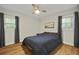 Bedroom with hardwood floors, ceiling fan, and windows allowing natural light at 96 King Charles Cir, Summerville, SC 29485