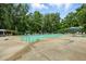 Large community pool surrounded by lounge chairs and umbrellas, offering a refreshing retreat for residents at 96 King Charles Cir, Summerville, SC 29485