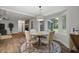 Cozy dining area features a decorative light fixture, four chairs, and a large sunny window at 96 King Charles Cir, Summerville, SC 29485