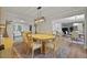 Inviting dining area with wood floors, contemporary light fixture, and seamless access to the kitchen at 96 King Charles Cir, Summerville, SC 29485