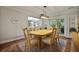 Elegant dining room with wood table, stylish lighting, and views to the back yard at 96 King Charles Cir, Summerville, SC 29485