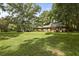 Beautiful brick home with an expansive lawn, mature trees, and a long driveway, blending classic charm with outdoor space at 96 King Charles Cir, Summerville, SC 29485