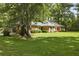 Well-maintained brick home with a lush green lawn, showcasing its inviting curb appeal in a serene, tree-filled setting at 96 King Charles Cir, Summerville, SC 29485