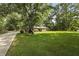 Picturesque brick home with an expansive green lawn and a long driveway, offering classic charm and ample outdoor space at 96 King Charles Cir, Summerville, SC 29485