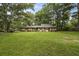 Attractive brick home nestled on a spacious lot with a lush green lawn and mature trees, creating a welcoming atmosphere at 96 King Charles Cir, Summerville, SC 29485