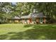 Charming brick home featuring a manicured lawn, classic shutters and a welcoming front entry, set in a verdant landscape at 96 King Charles Cir, Summerville, SC 29485