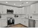 Bright kitchen features stainless steel appliances, white cabinetry, and stylish marble tile backsplash at 96 King Charles Cir, Summerville, SC 29485