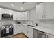 Bright kitchen features stainless steel appliances, white cabinetry, and stylish marble tile backsplash at 96 King Charles Cir, Summerville, SC 29485