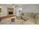 Comfortable living room featuring a brick fireplace, ceiling fan, and cozy sectional sofa at 96 King Charles Cir, Summerville, SC 29485