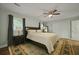 Inviting bedroom with a dark wood bed frame, light colored walls, and ceiling fan at 96 King Charles Cir, Summerville, SC 29485