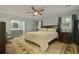 Bright main bedroom with a ceiling fan, en-suite bathroom, and natural light at 96 King Charles Cir, Summerville, SC 29485