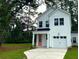 Beautiful two-story house with white siding, a neatly kept yard, and an attached garage at 100 Claret Cup Way, Charleston, SC 29414