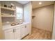 Lovely pantry with floating wood shelves above bright white cabinets, next to a spacious storage area at 1010 Universal Cir, Saint Stephen, SC 29479