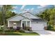 Charming single-story home featuring a two-car garage, covered porch, and a beautifully landscaped front yard at 106 Barker Street, Summerville, SC 29486