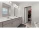Well-lit bathroom featuring double sinks, modern fixtures, and a walk-in closet at 106 Claremont Ct, Summerville, SC 29486