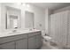 Bathroom featuring double vanity, gray cabinets and a patterned shower curtain at 106 Claremont Ct, Summerville, SC 29486