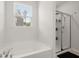 Bright bathroom with a soaking tub, shower, window, and modern fixtures at 106 Claremont Ct, Summerville, SC 29486