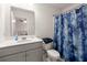 This bathroom features a shower with blue decorative shower curtain, a toilet, and a sink at 106 Claremont Ct, Summerville, SC 29486