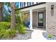 Welcoming front porch with brick accents, manicured landscaping, and a charming blue chair near the front door at 106 Claremont Ct, Summerville, SC 29486