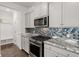 Modern kitchen boasts granite countertops, stainless appliances, and tile backsplash at 106 Claremont Ct, Summerville, SC 29486