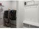 Well-lit laundry room with modern washer and dryer and built-in storage at 106 Claremont Ct, Summerville, SC 29486