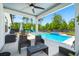 Covered patio area with outdoor seating looking onto the pool, spa, and backyard at 106 Claremont Ct, Summerville, SC 29486