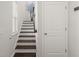 Staircase with decorative wall art, hardwood treads, and white risers leading to the upper level at 106 Claremont Ct, Summerville, SC 29486