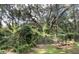 The backyard features lawn, a garden plot, and mature trees beyond the fence line at 109 Rosefield Ct, Summerville, SC 29485